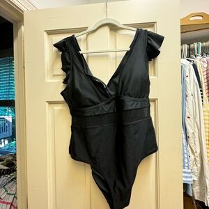 One piece with ruffle shoulders and mesh waist detail